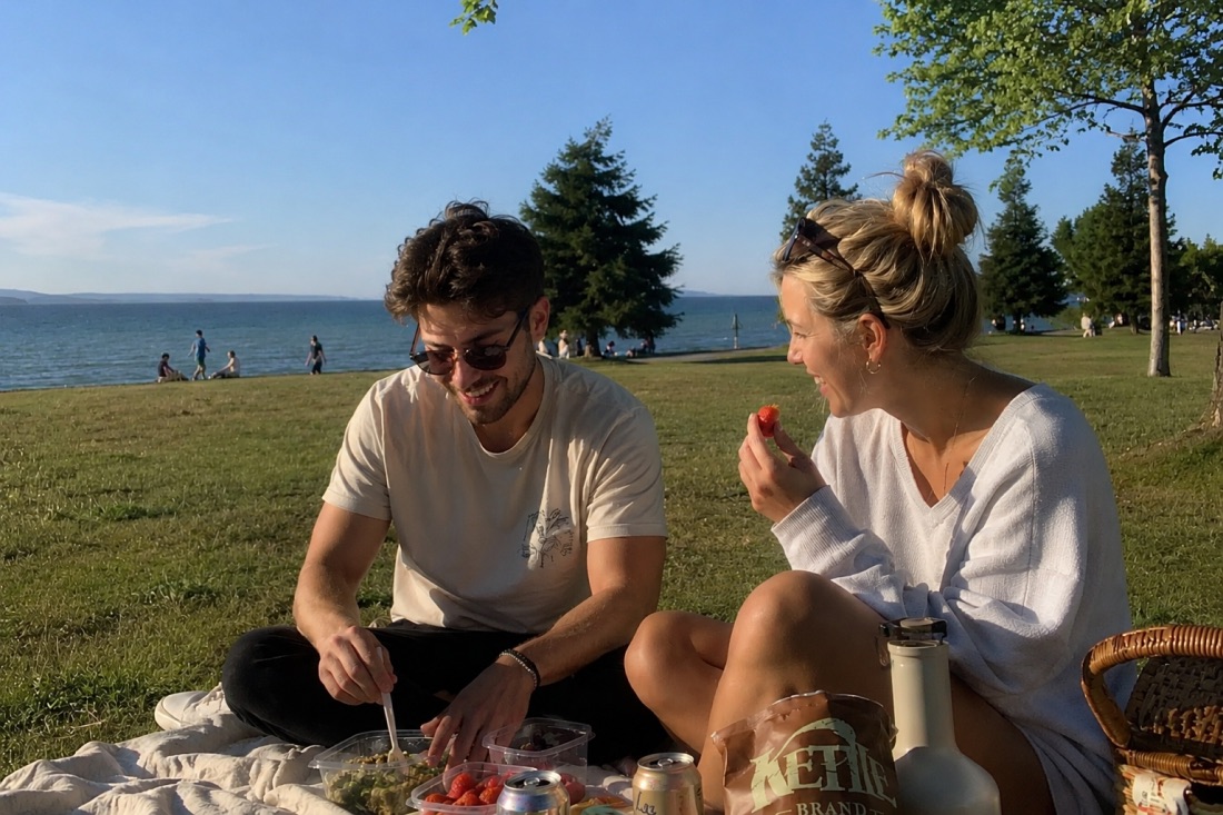 A couple having a picnic by the water